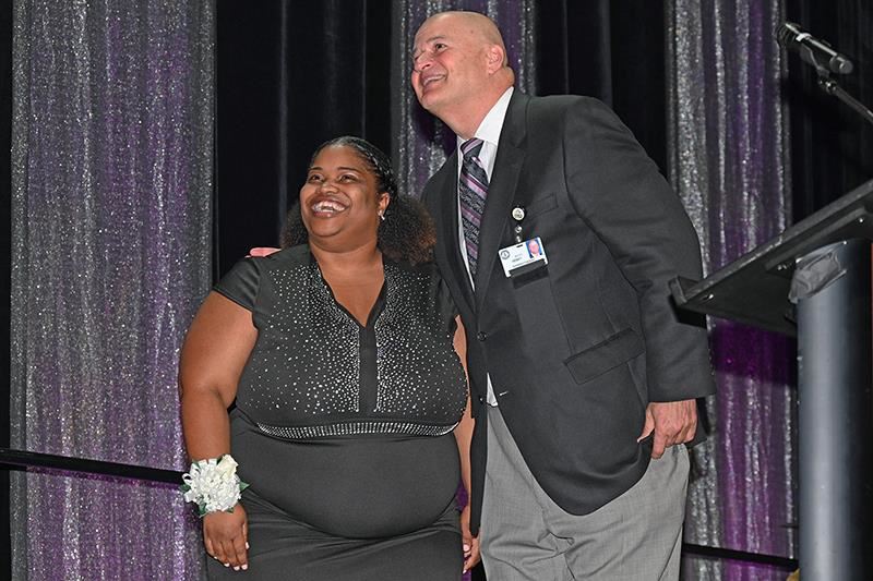 Lekeisha Bryant, Andre’ Elementary School Teacher of the Year honoree, is congratulated by Dr. Mark Henry.